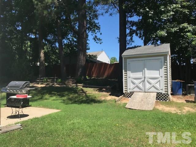 3512 Rendition Street Raleigh, NC 27610 - Photo 21 of 26 a backyard of a house with table and chairs