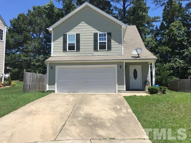 3512 Rendition Street Raleigh, NC 27610 - Photo 24 of 26 a front view of a house with a yard and garage