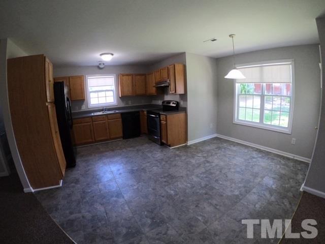 3512 Rendition Street Raleigh, NC 27610 - Photo 4 of 26 a kitchen with refrigerator and window