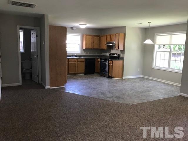 3512 Rendition Street Raleigh, NC 27610 - Photo 6 of 26 a kitchen with stainless steel appliances granite countertop a refrigerator a sink a stove with wooden cabinets