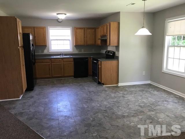 3512 Rendition Street Raleigh, NC 27610 - Photo 8 of 26 a kitchen with a refrigerator and a sink