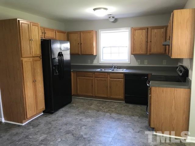 3512 Rendition Street Raleigh, NC 27610 - Photo 9 of 26 a kitchen with stainless steel appliances granite countertop a refrigerator sink and cabinets