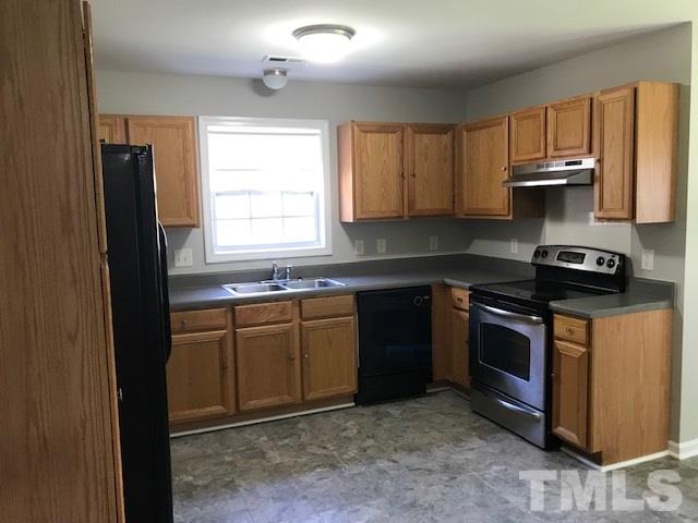 3512 Rendition Street Raleigh, NC 27610 - Photo 10 of 26 a kitchen with stainless steel appliances granite countertop a stove a sink and a microwave