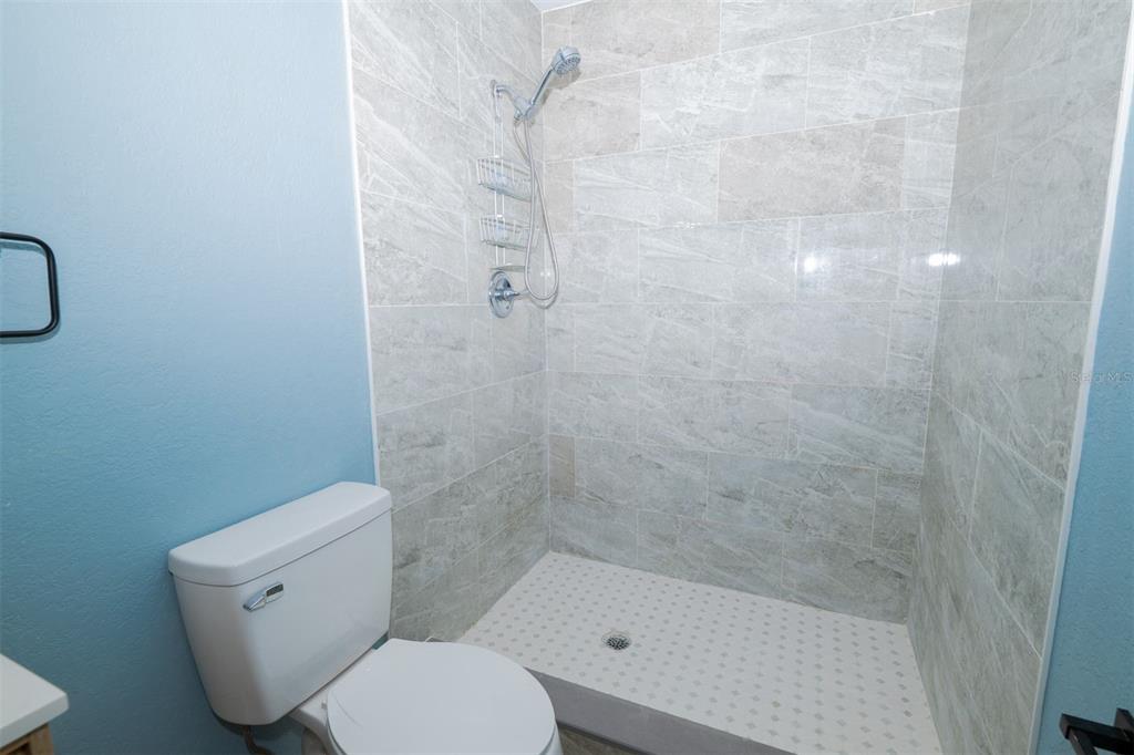 9330 Southeast Maricamp Road Ocala, FL 34472 - Photo 14 of 19 a white toilet sitting next to a bath tub
