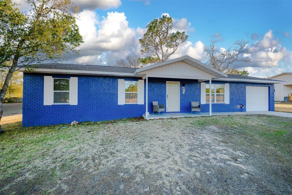 9330 Southeast Maricamp Road Ocala, FL 34472 - Photo 2 of 19 a view of a house with a yard