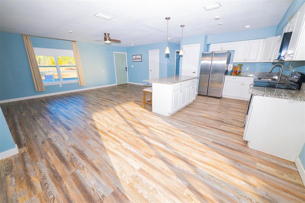 9330 Southeast Maricamp Road Ocala, FL 34472 - Photo 8 of 19 a view of kitchen and wooden floor