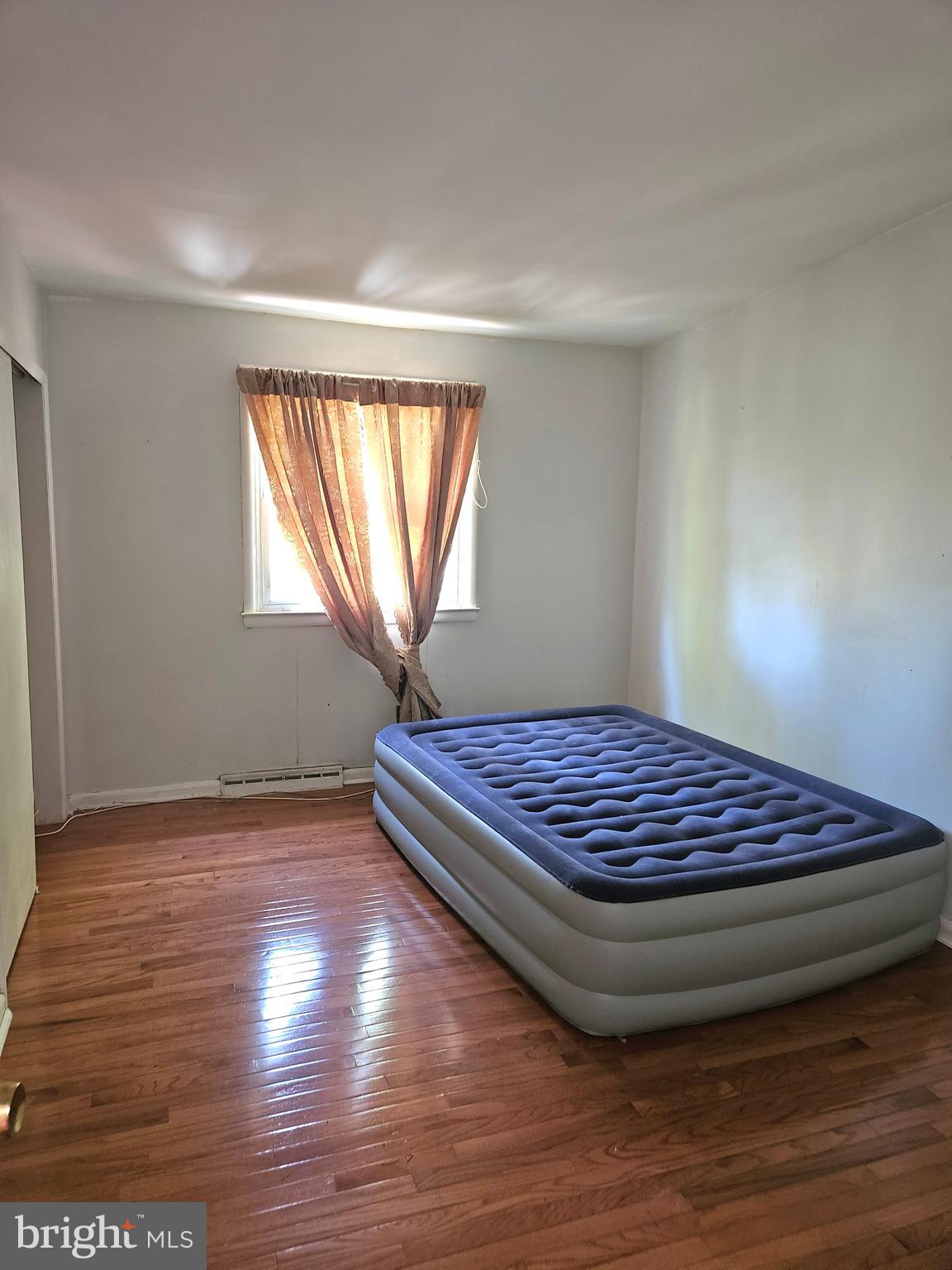 148 Church Road Elkins Park, PA 19027 - Photo 20 of 33 a view of an empty room with wooden floor and a window
