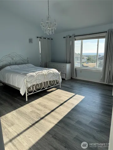 a spacious bedroom with a large bed and a window
