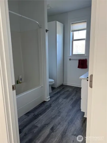 a view of a bathroom with a bathtub and window