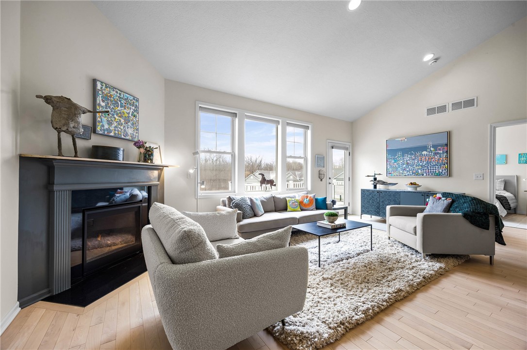 6002 Woodvine Rise Canandaigua, NY 14424 - Photo 14 of 50 Corner gas fireplace with tile surround and wood m