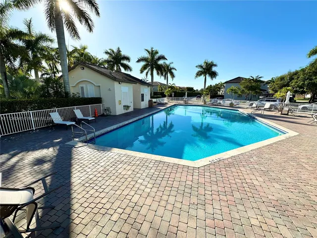 a view of a house with swimming pool and sitting area