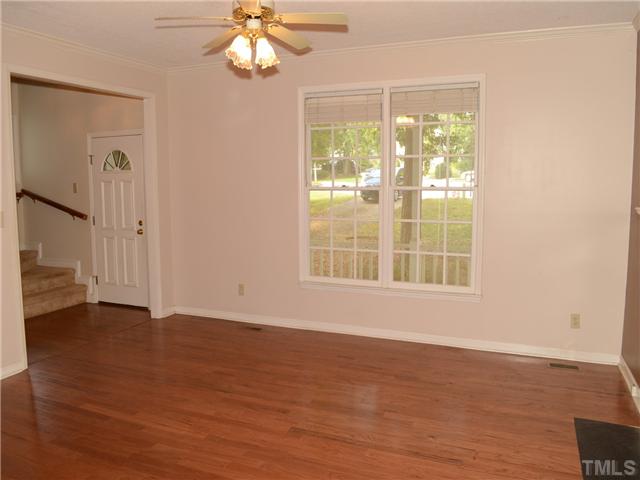 4516 Emmit Drive Raleigh, NC 27604 - Photo 6 of 13 a view of an empty room with wooden floor and a window