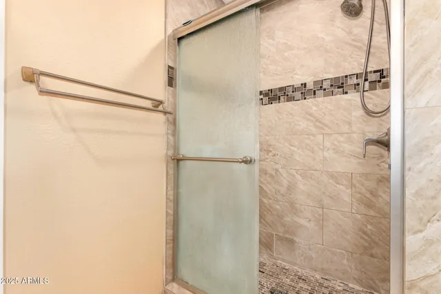 a bathroom with a glass shower door
