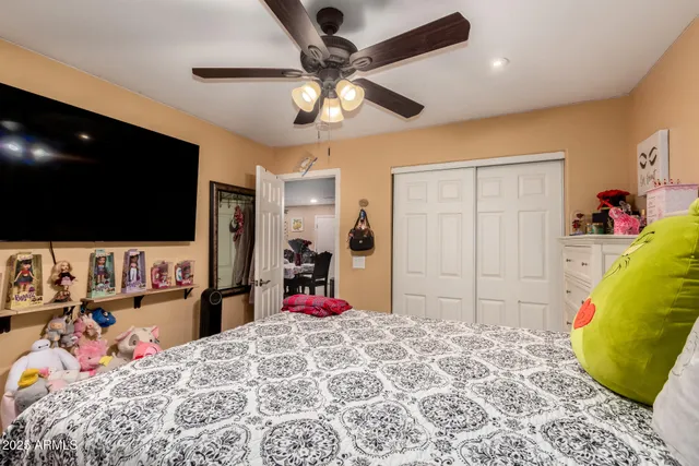 a bed room with a bed and a flat screen tv