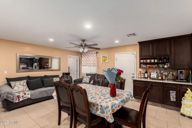 a living room with furniture and a dining table with kitchen view
