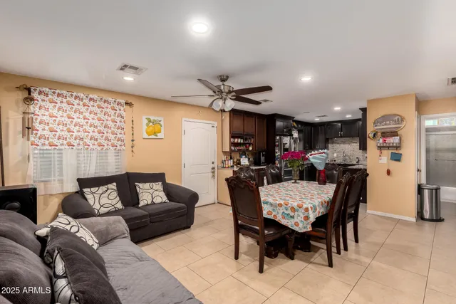 a living room with furniture and kitchen view