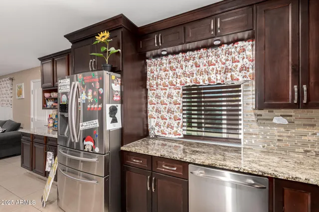 a kitchen with stainless steel appliances granite countertop a sink and a shower
