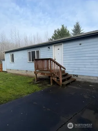 a view of backyard with deck and outdoor seating
