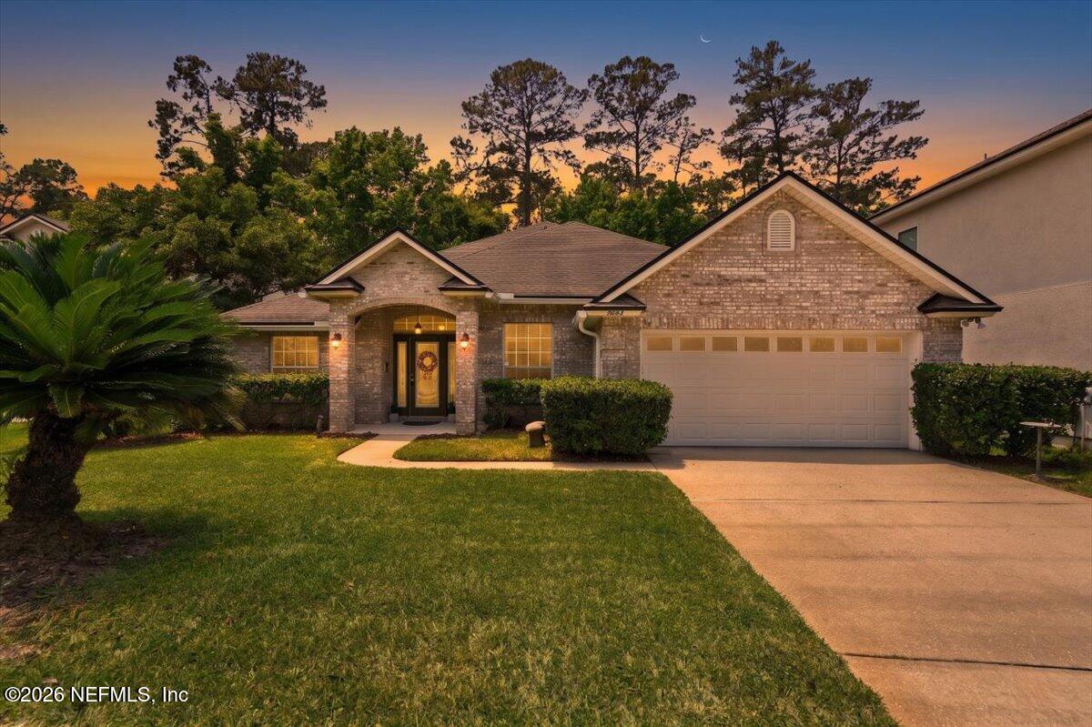 a front view of a house with a yard and garage