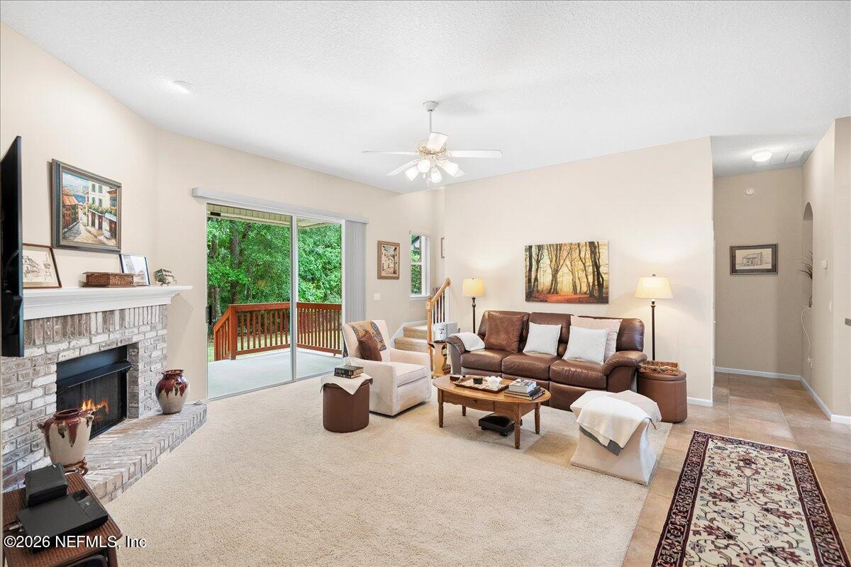 2489 Tall Cedars Road Fleming Island, FL 32003 - Photo 13 of 72 a living room with furniture and a fireplace