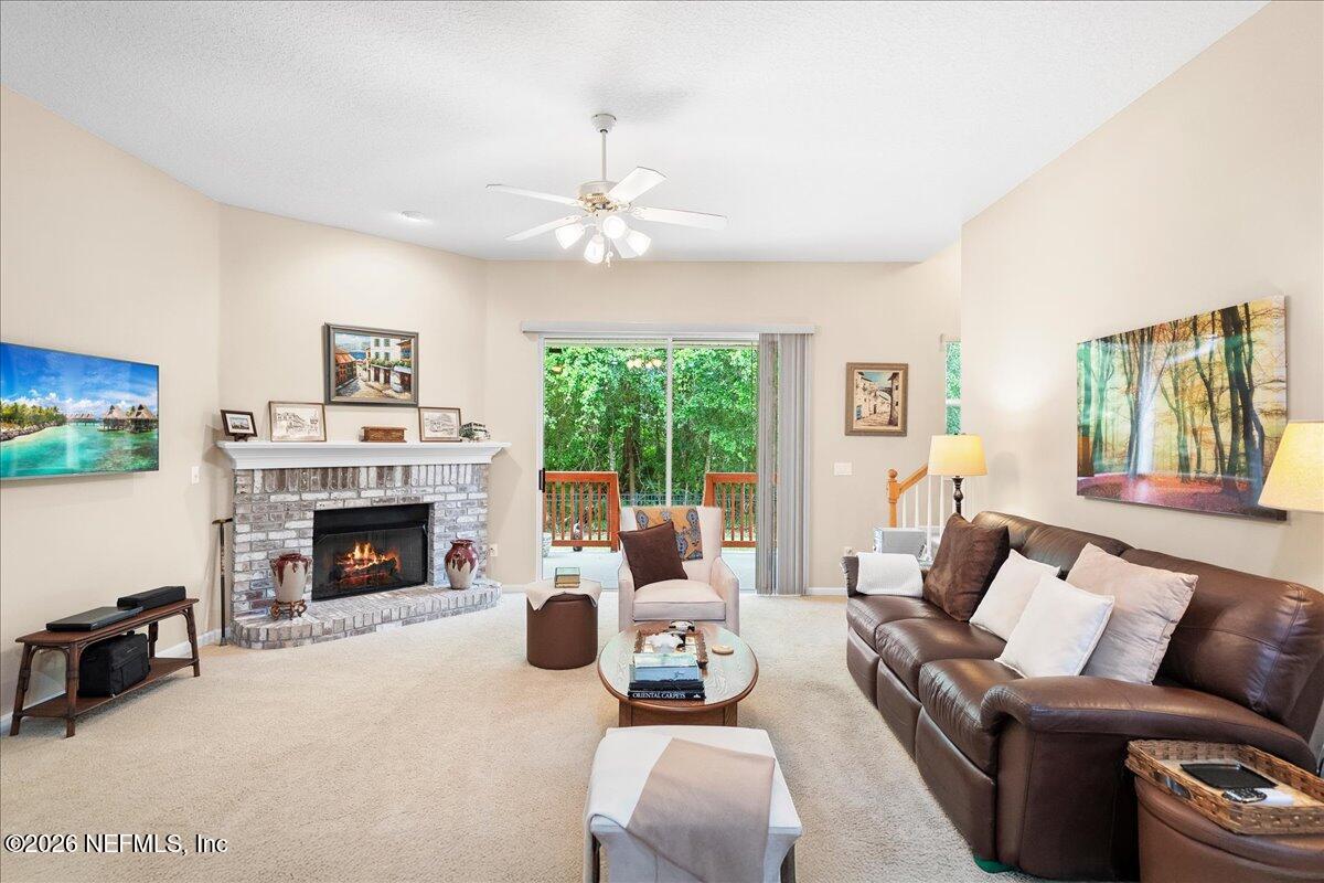 2489 Tall Cedars Road Fleming Island, FL 32003 - Photo 14 of 72 a living room with furniture fireplace and a large window