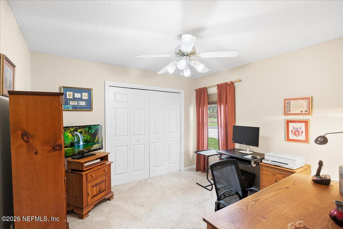 2489 Tall Cedars Road Fleming Island, FL 32003 - Photo 16 of 72 a view of a workspace with furniture and a window