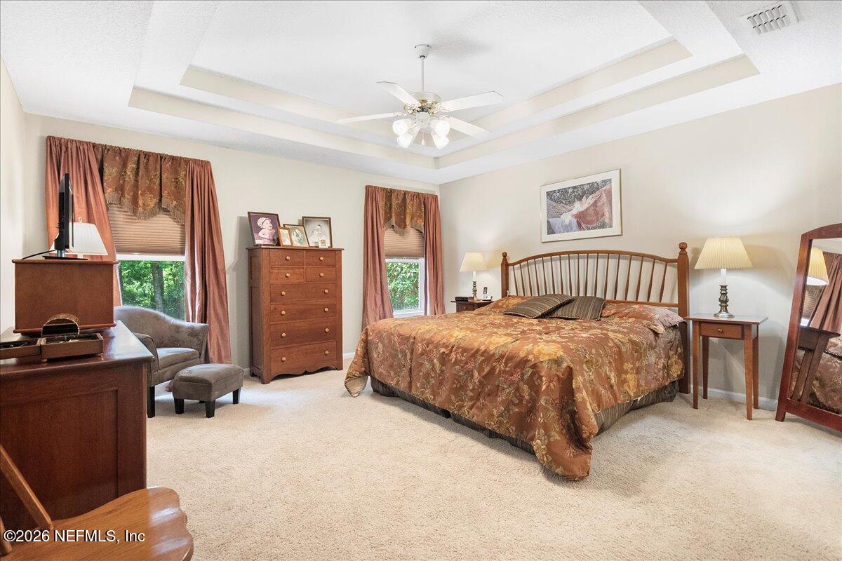 2489 Tall Cedars Road Fleming Island, FL 32003 - Photo 20 of 72 a spacious bedroom with a bed and a desk
