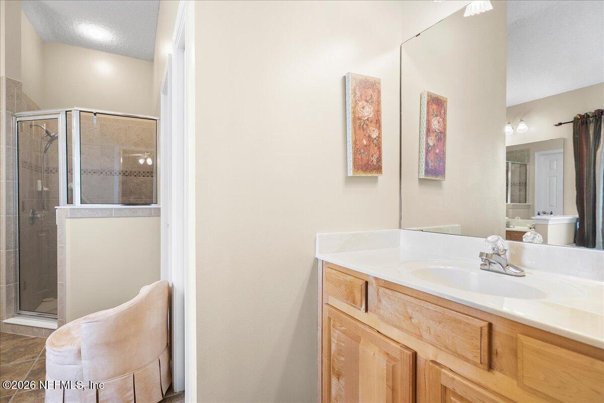 2489 Tall Cedars Road Fleming Island, FL 32003 - Photo 26 of 72 a bathroom with a sink and a mirror