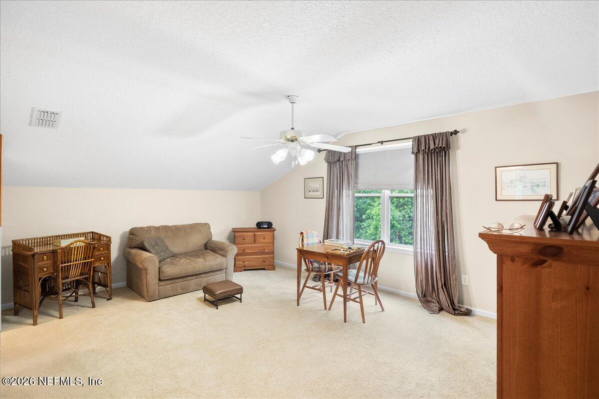 2489 Tall Cedars Road Fleming Island, FL 32003 - Photo 28 of 72 a living room with furniture and a large window