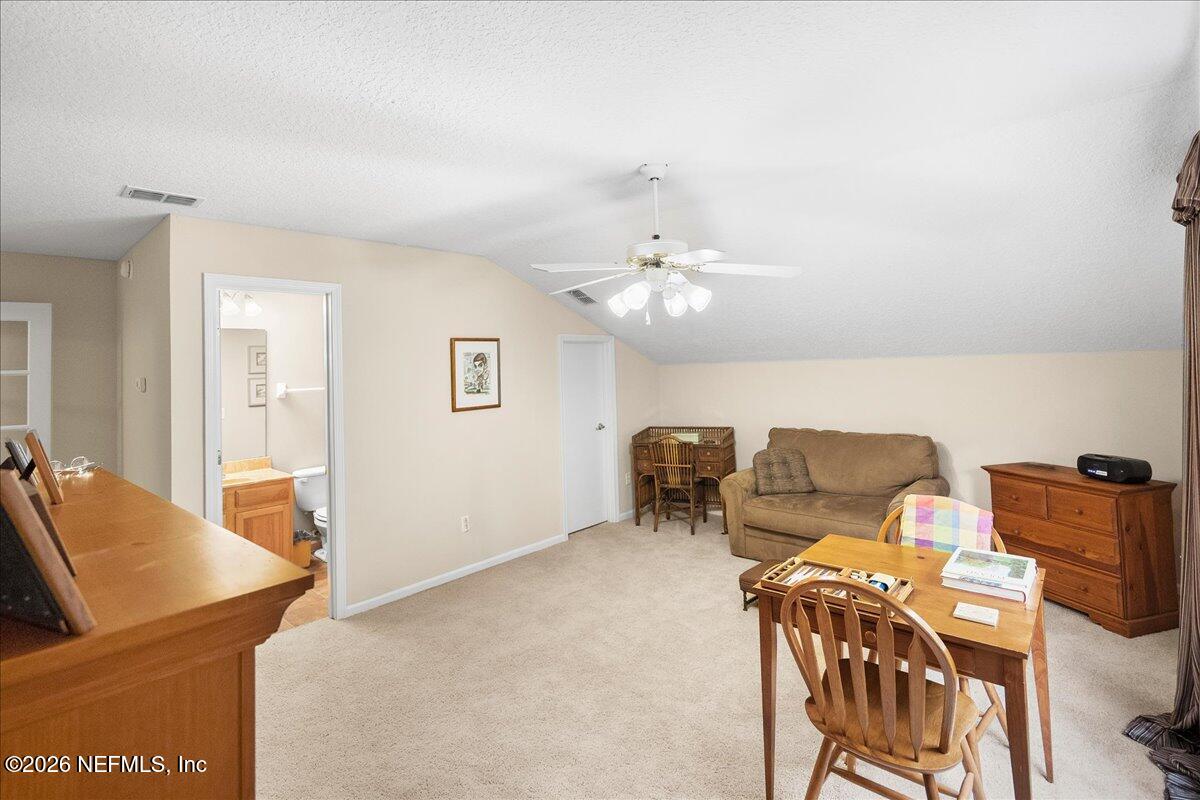 2489 Tall Cedars Road Fleming Island, FL 32003 - Photo 29 of 72 a living room with furniture and a chandelier