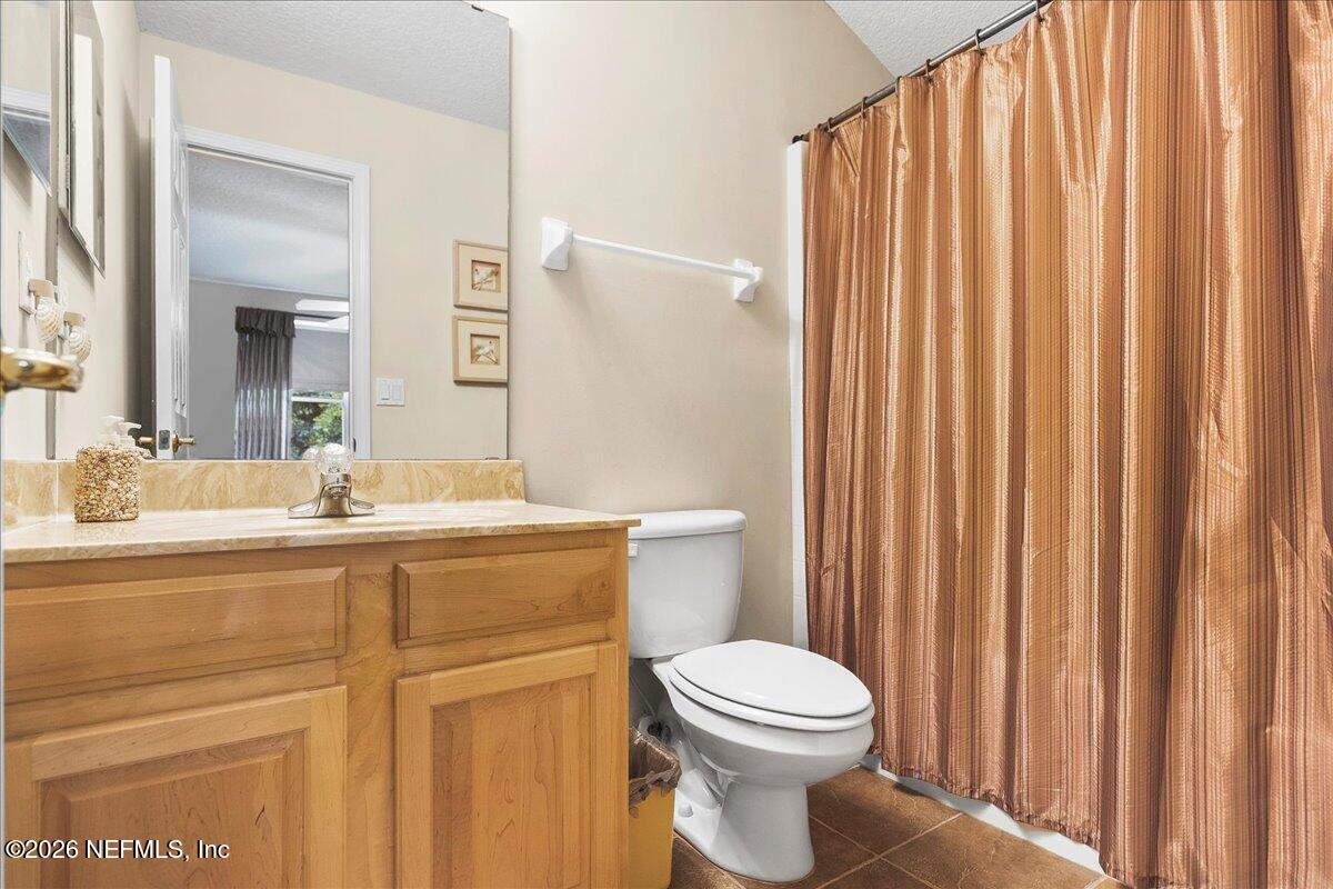 2489 Tall Cedars Road Fleming Island, FL 32003 - Photo 30 of 72 a bathroom with a toilet a sink and a mirror