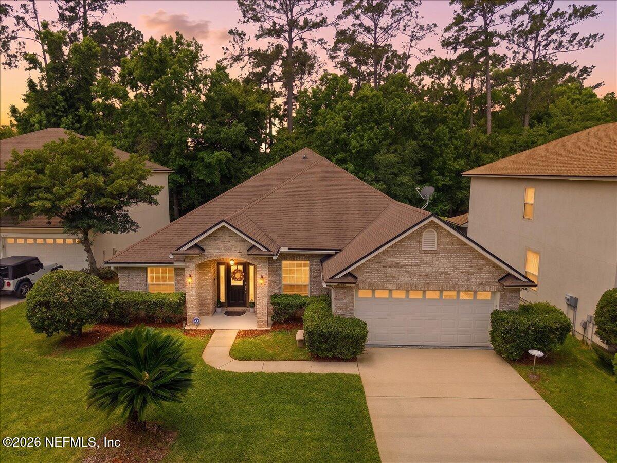 2489 Tall Cedars Road Fleming Island, FL 32003 - Photo 37 of 72 a front view of a house with garden