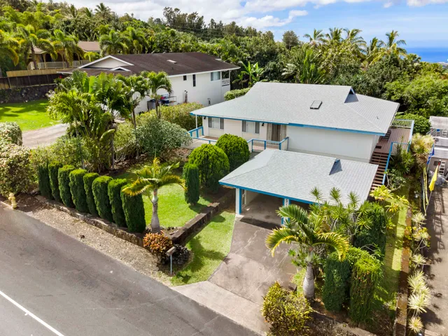 an aerial view of a house with yard and outdoor seating