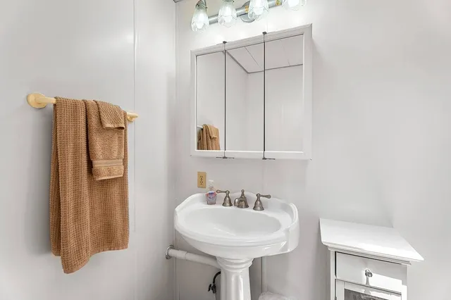 a bathroom with a sink and mirror