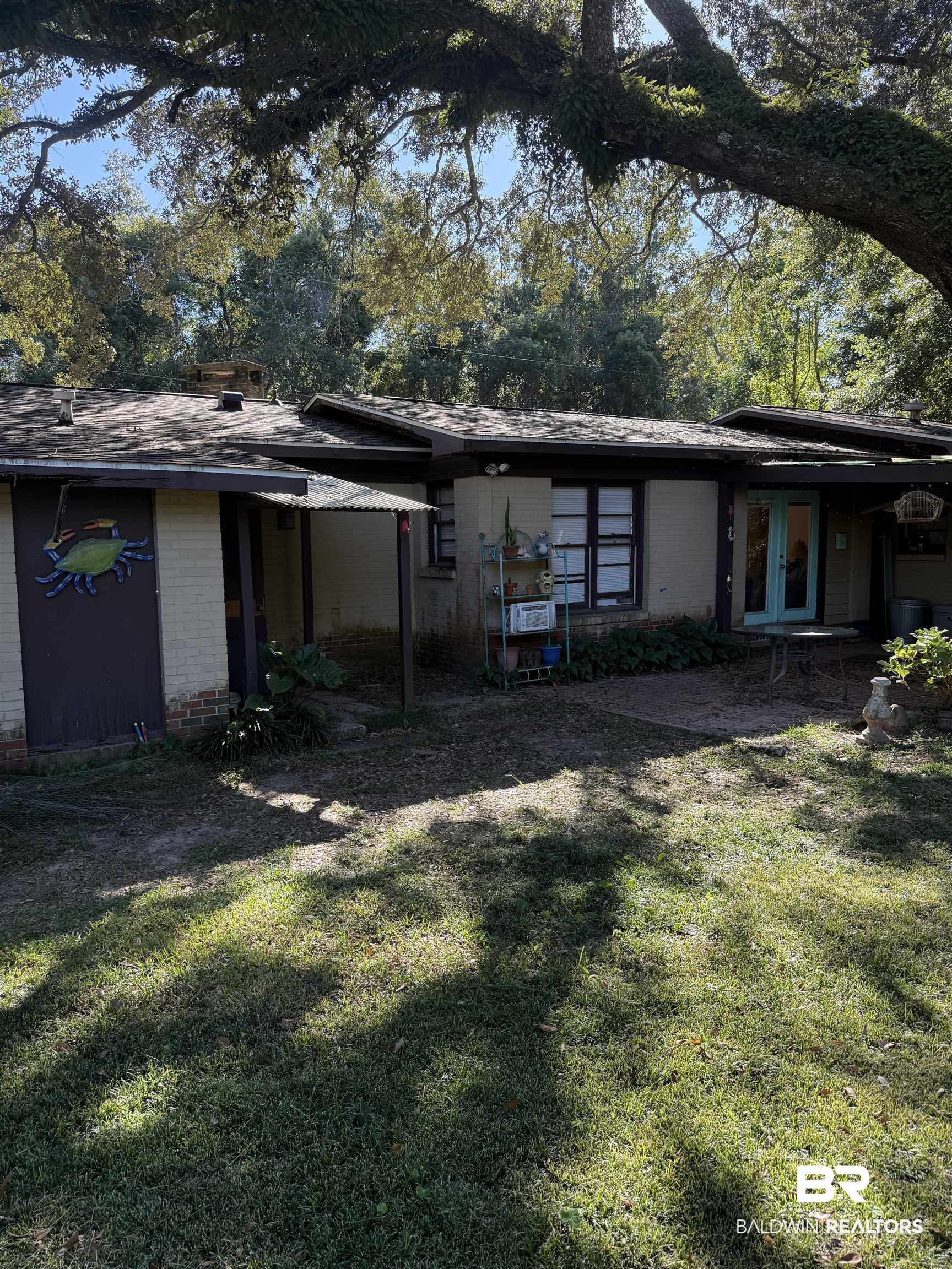 22173 1st Street Silverhill, AL 36576 - Photo 16 of 16 Back of property with brick siding, a lawn, and french doors