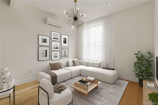 a living room with furniture a chandelier and a window