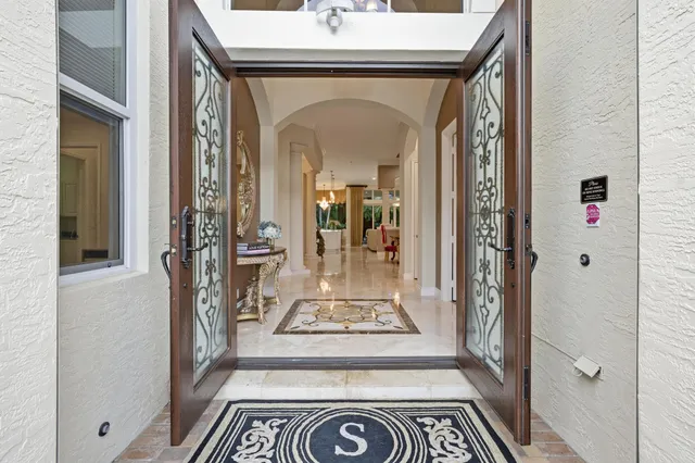 a kitchen with stainless steel appliances kitchen island a table chairs in it and wooden floors