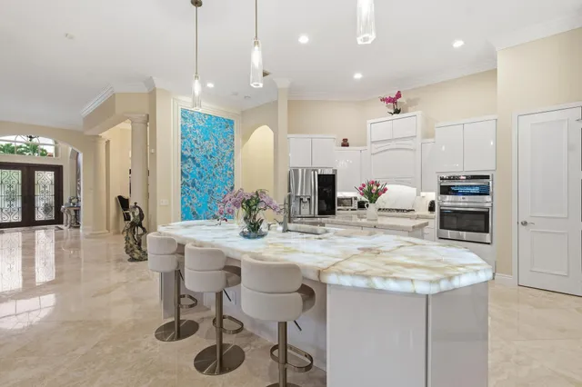 a dining room with furniture a chandelier and window