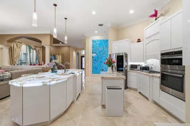 a living room with furniture a chandelier and a flat screen tv