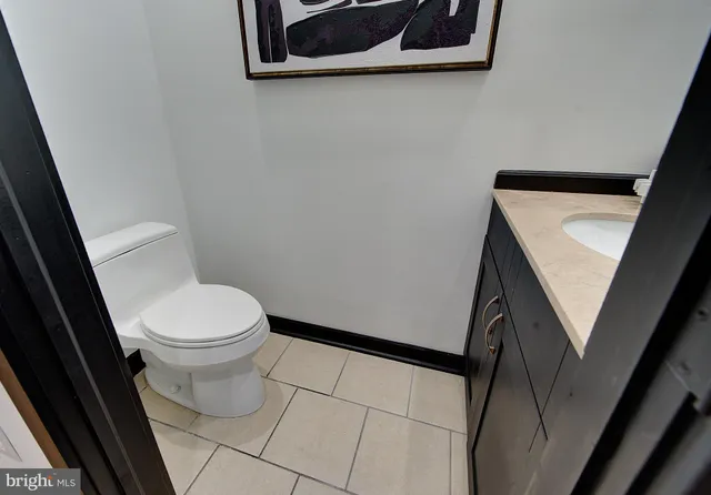 a large kitchen with kitchen island a large counter top stainless steel appliances and cabinets