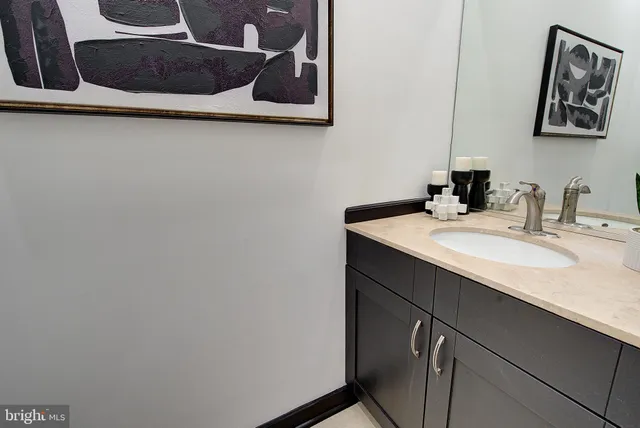 a kitchen with stainless steel appliances kitchen island granite countertop a refrigerator and a sink