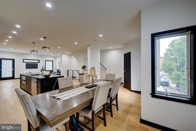 a view of empty room with wooden floor and cabinet