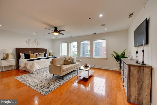 a bathroom with a granite countertop sink and a bathtub