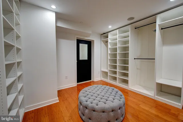 a view of a hallway with wooden floor and stairs