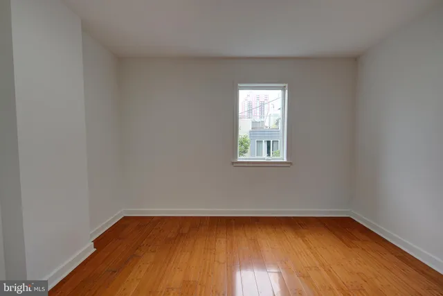 a view of an empty room with stairs and furniture