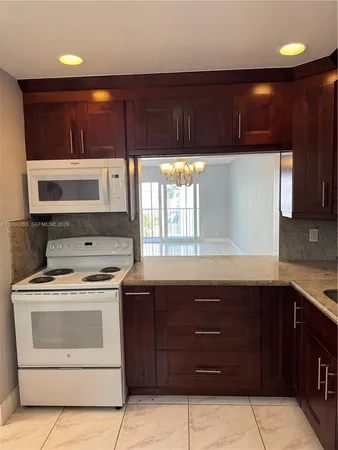 a kitchen with a sink and a stove top oven