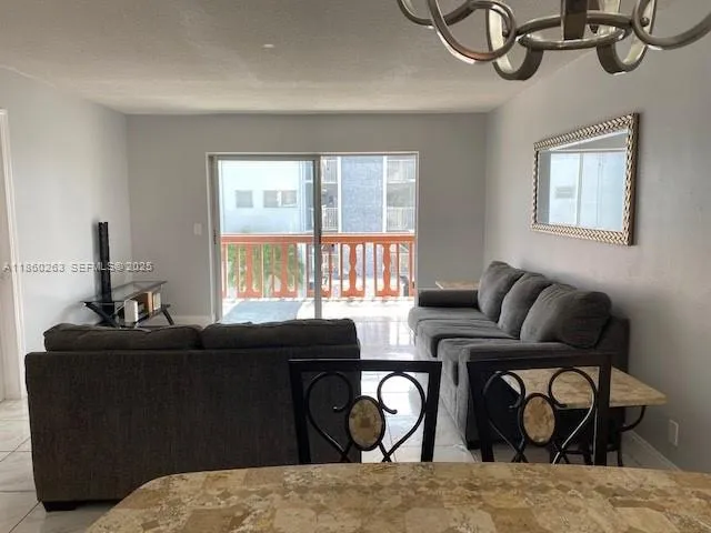 a living room with furniture a window and wooden floor