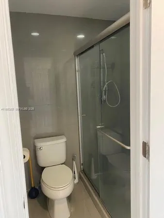 a view of a patio with a table and chairs under an umbrella
