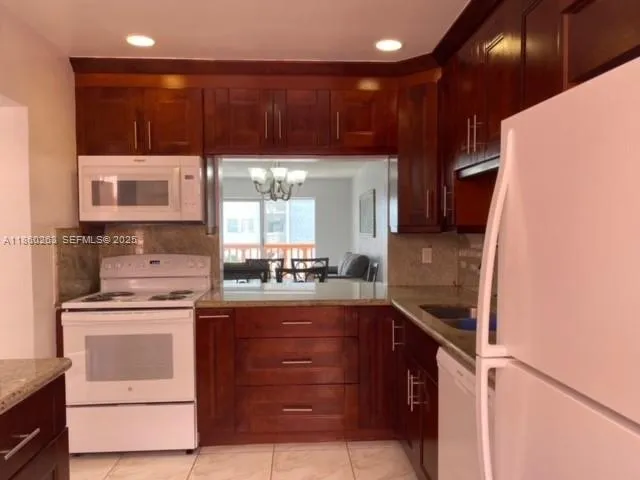 a kitchen with a stove and a refrigerator