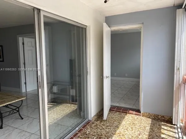 a view of an empty room with a mirror